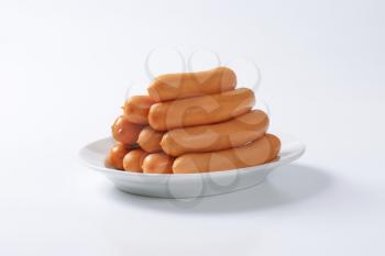 Pile of Vienna sausages on plate