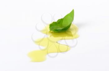 Olive oil drizzle and fresh basil leaf