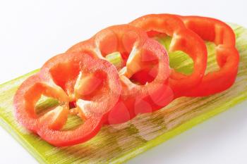 slices of red bell pepper on wooden cutting board