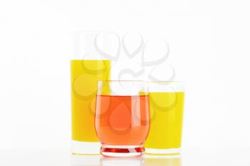 Glasses of fruit juice drinks  on white background