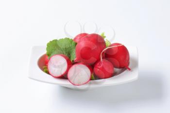 Fresh red radishes in a bowl