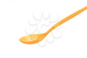 Orange plastic spoon on white background