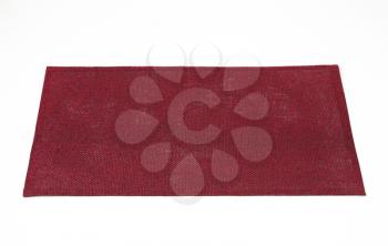 Rectangular burgundy place mat on white background