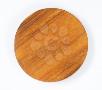 round wood chopping board on white background