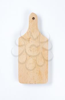 small wooden paddle cutting board
