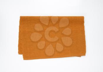 Brown woven cotton place mat folded in half