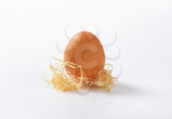 egg with straw on white background