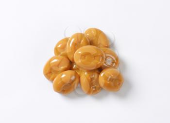 handful of caramel candies on white background