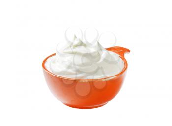 creme fraiche in an orange bowl isolated on white
