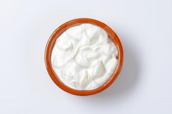 white yogurt in a ceramic bowl