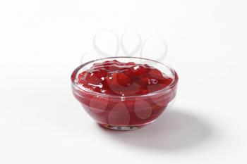 bowl of strawberry jam on white background