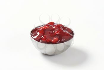 bowl of strawberry jam on white background