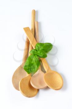 variety of wooden spoons on off-white background
