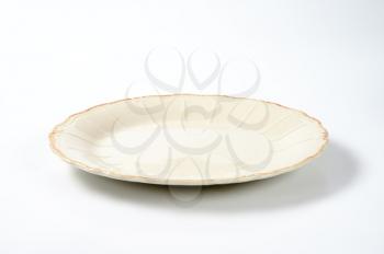 dinner plate with embossed lines and subtle scalloped edge