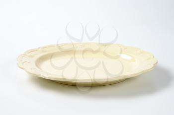 beige plate with embossed rim