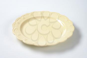 beige plate with embossed rim
