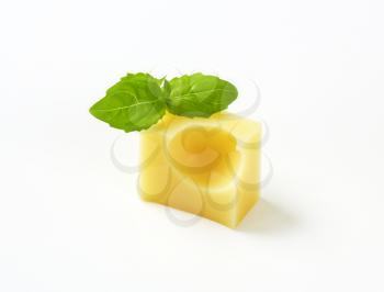cube of fresh emmental cheese on white background