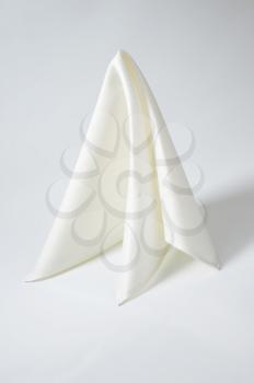 white cloth napkin on off-white background