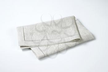 folded light grey cloth place mat
