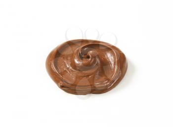 swirl of chocolate spread on white background