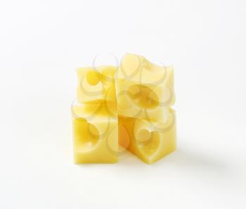 cubes of fresh emmental cheese on white background