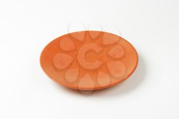 Single empty terracotta dinner plate