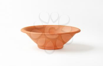 Empty round red clay bowl