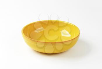 Empty round yellow ceramic bowl