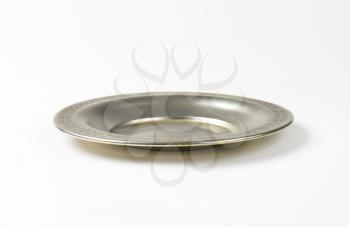 Vintage metal saucer plate with decorative rim