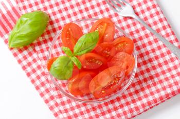 Halved fresh oval-shaped red tomatoes
