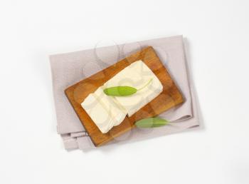 block of fresh tofu on cutting board