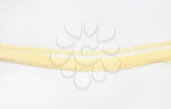 Coarse semolina flour on off-white background