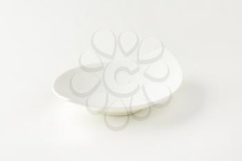 empty curved white bowl on white background