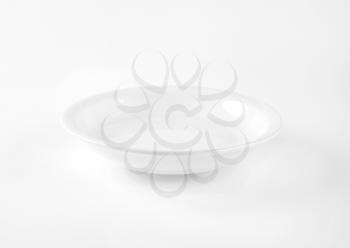 coupe shaped soup plate on white background