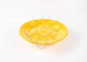 empty yellow plate on white background