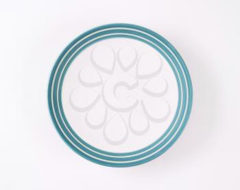 white plate with blue bands along the edge