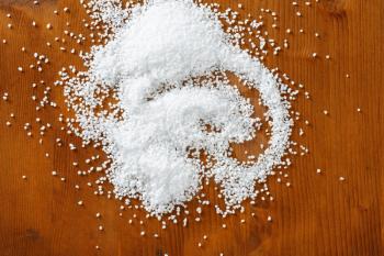 Coarse grained salt on wooden table