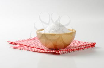 Coarse grained salt in wooden bowl
