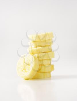 stack of banana slices on white background