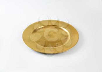 Round gold charger plate with wide rim