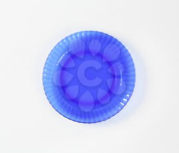 Scalloped blue glass salad plate with swirl rim