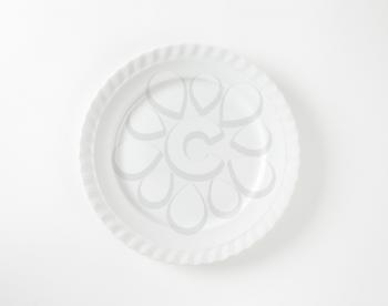 Elegant white porcelain dinner plate with swirl edge