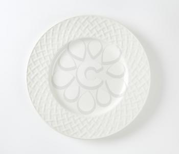 White porcelain plate with lattice pattern on the rim