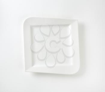 Square dinner plate with irregular rim