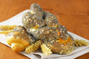 Braided bread rolls topped with poppy seeds and salt