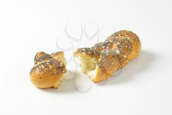 Pieces of braided poppy seed bread roll