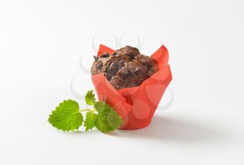 Double chocolate chip muffin wrapped in red paper