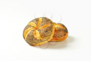 two fresh poppy seed buns on white background