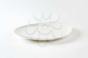 Oval white porcelain plate with pointed ends