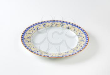 Country style dinner plate with floral design border and brown trim